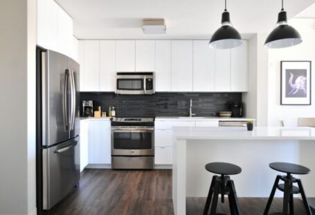 Property Value - gray steel 3-door refrigerator near modular kitchen